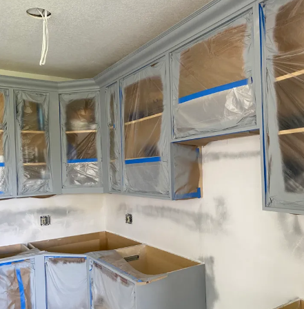 Freshly spray-painted kitchen cabinets with smooth flawless white factory finish by Vital Homes Painting, showing zero brush marks or texture.
